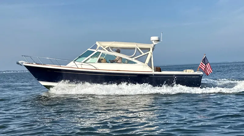 Slide: The Image of 2009 Hunt Yachts Harrier 29 cruising on open water with American flag. - 2