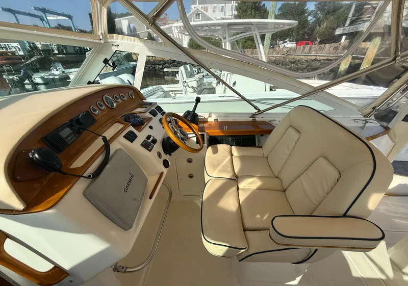 Slide: The Image of 2009 Hunt Yachts Harrier 29 helm with beige seating and wooden dashboard. - 21