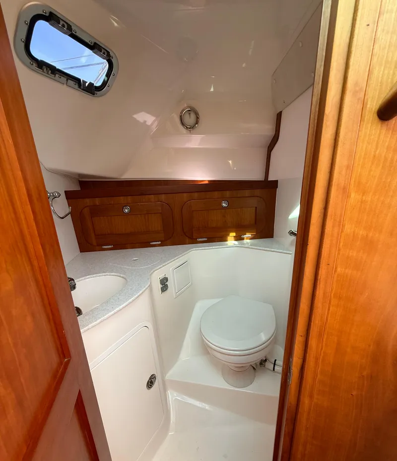 Slide: The Image of 2009 Hunt Yachts Harrier 29 bathroom with wooden cabinets and compact design. - 25