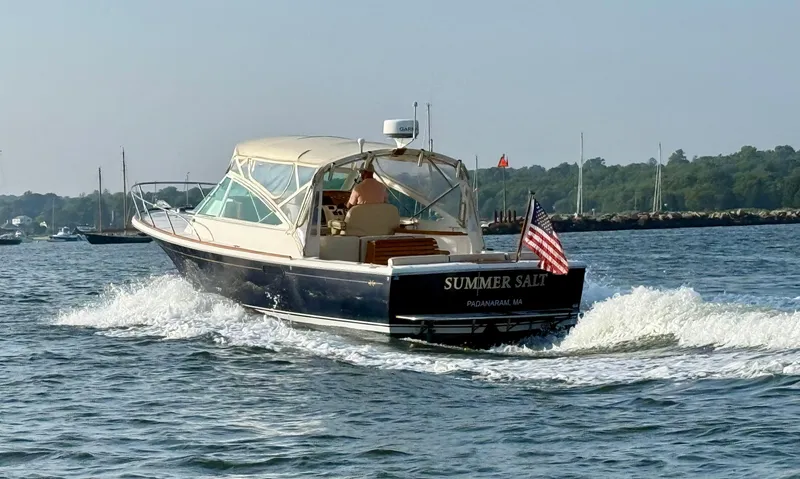 Slide: The Image of 2009 Hunt Yachts Harrier 29 cruising on open water with American flag. - 4