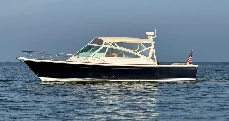 Slide: The Image of 2009 Hunt Yachts Harrier 29 cruising on open water with American flag. - 6