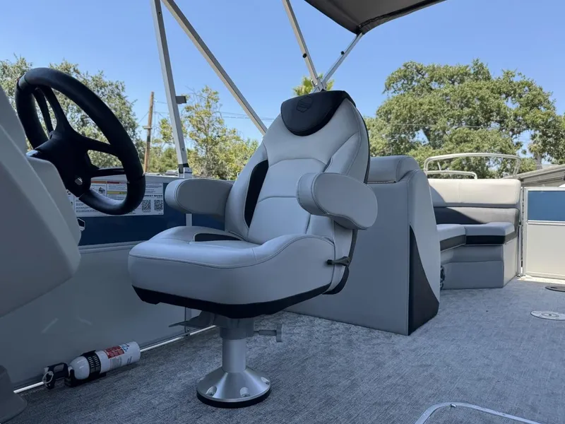 Slide: The Image of 2025 South Bay 222 LE boat interior with captain's chair and seating area. - 10