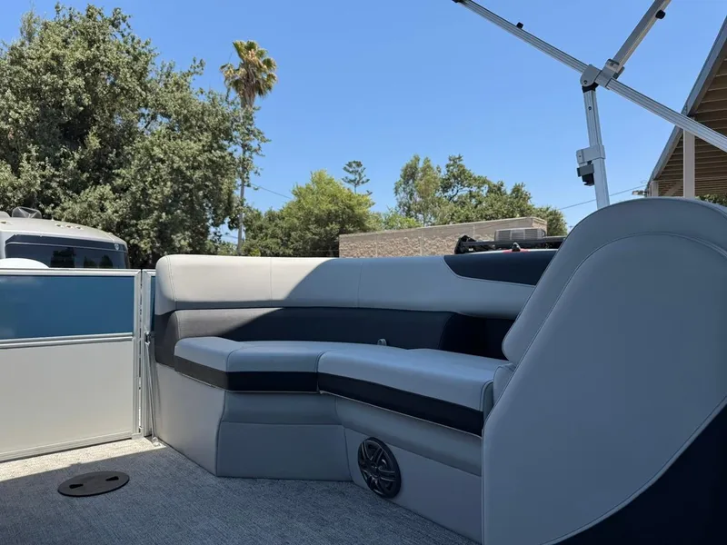 Slide: The Image of 2025 South Bay 222 LE pontoon boat interior with gray seating and blue accents. - 12