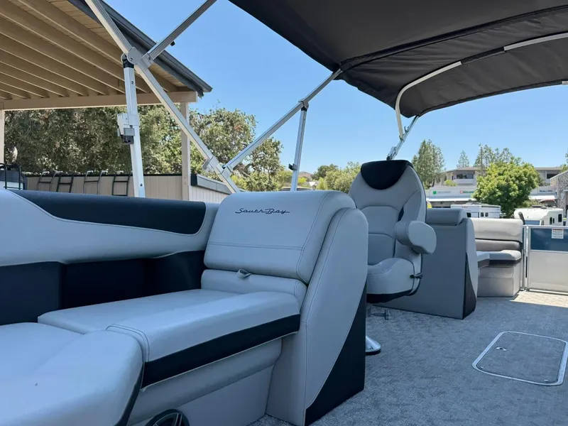 Slide: The Image of 2025 South Bay 222 LE pontoon boat interior with plush seating and canopy. - 16