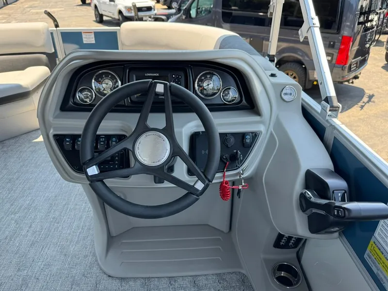Slide: The Image of 2025 South Bay 222 LE boat dashboard with steering wheel and control panel. - 18