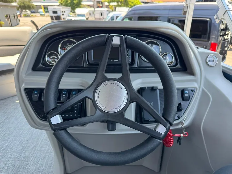 Slide: The Image of Steering wheel of 2025 South Bay 222 LE boat with dashboard controls. - 23