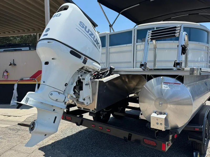 Slide: The Image of 2025 South Bay 222 LE pontoon boat with Suzuki outboard motor on trailer. - 28