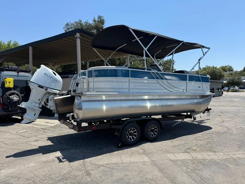 Slide: The Image of 2025 South Bay 222 LE pontoon boat on trailer with Suzuki outboard motor. - 3