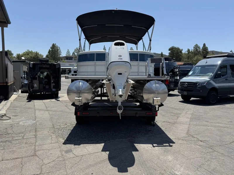 Slide: The Image of 2025 South Bay 222 LE pontoon boat on trailer, parked outdoors. - 32