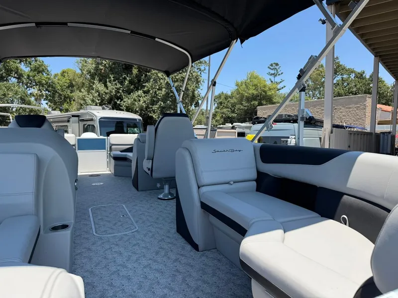 Slide: The Image of 2025 South Bay 222 LE pontoon boat interior with plush seating and canopy. - 5