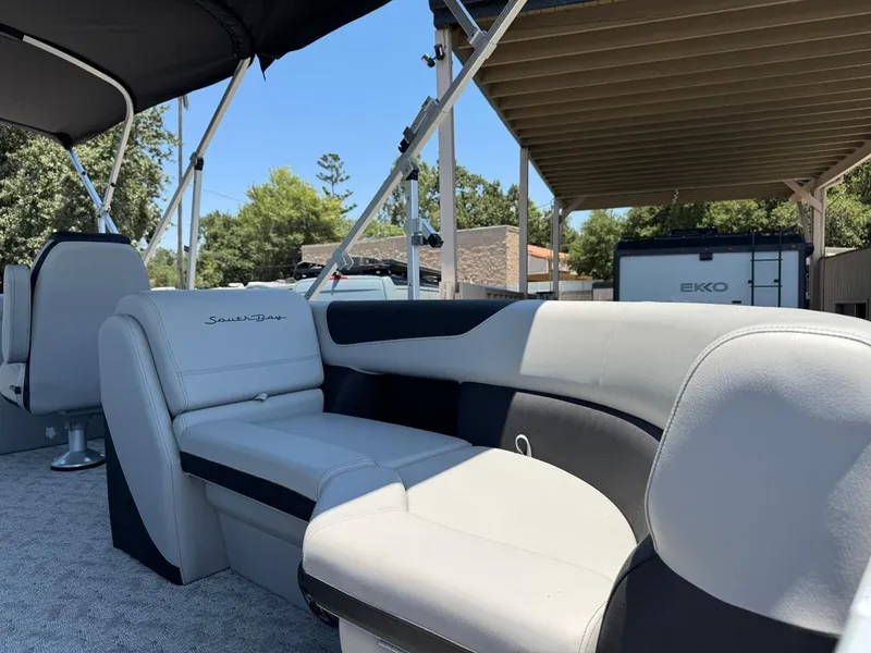 Slide: The Image of 2025 South Bay 222 LE pontoon boat interior with plush seating and canopy. - 6