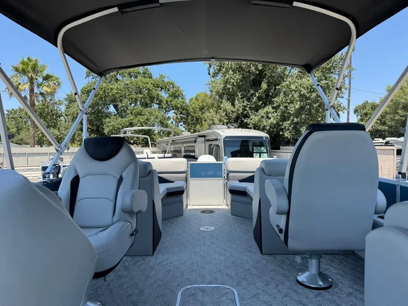 Slide: The Image of 2025 South Bay 222 LE pontoon boat interior with plush seating and canopy. - 8