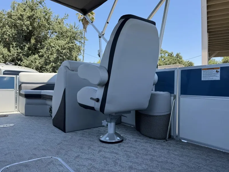 Slide: The Image of 2025 South Bay 222 LE pontoon boat interior with seating and helm chair. - 9