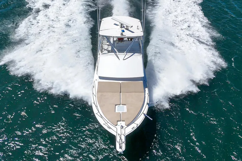 Slide: The Image of 2009 Egg Harbor 37 SportYacht cruising on open water, creating a dynamic wake. - 13