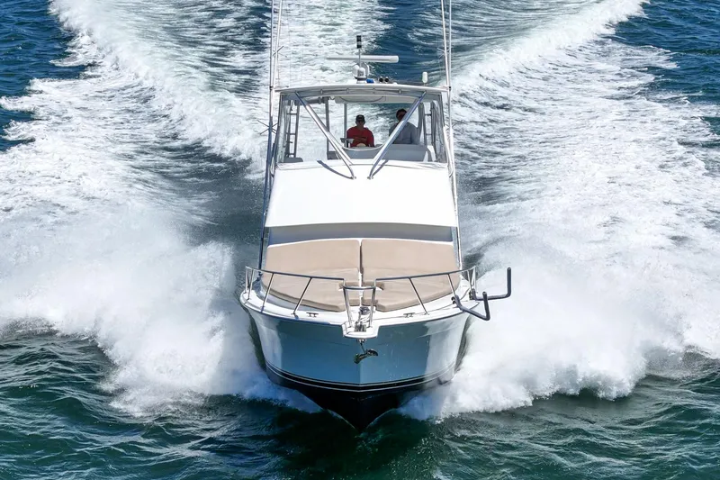 Slide: The Image of 2009 Egg Harbor 37 SportYacht cruising on open water, creating a dynamic wake. - 14
