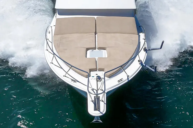 Slide: The Image of 2009 Egg Harbor 37 SportYacht cruising on water, aerial view of bow with sunpads. - 15
