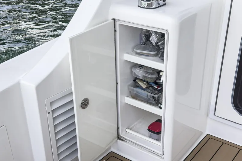 Slide: The Image of Open storage compartment on 2009 Egg Harbor 37 SportYacht with organized fishing gear. - 26