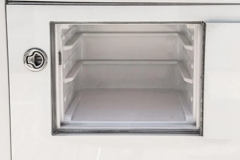 Slide: The Image of Storage compartment on a 2009 Egg Harbor 37 SportYacht, featuring a secure latch. - 27