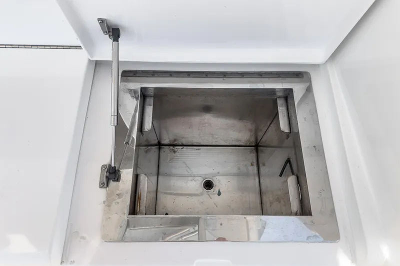 Slide: The Image of Open storage compartment on 2009 Egg Harbor 37 SportYacht, featuring stainless steel interior. - 29