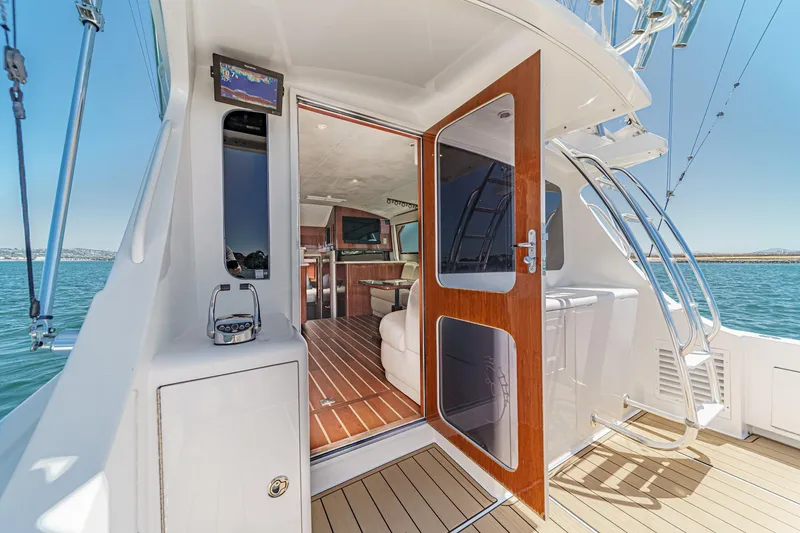 Slide: The Image of 2009 Egg Harbor 37 SportYacht interior view with open door, showcasing luxurious cabin. - 31