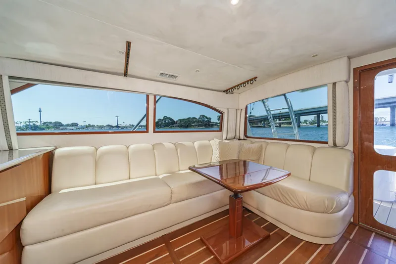 Slide: The Image of Luxurious interior of 2009 Egg Harbor 37 SportYacht with cream leather seating and wooden table. - 38