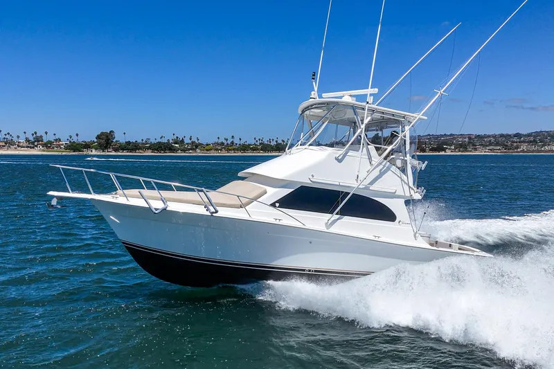 Slide: The Image of 2009 Egg Harbor 37 SportYacht cruising on open water under clear blue skies. - 4