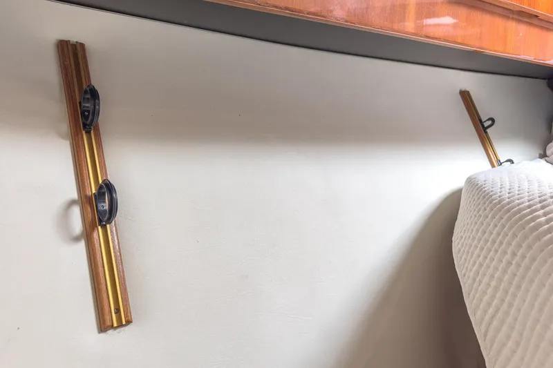 Slide: The Image of Interior of 2009 Egg Harbor 37 SportYacht with wooden wall fixtures and white bedding. - 42