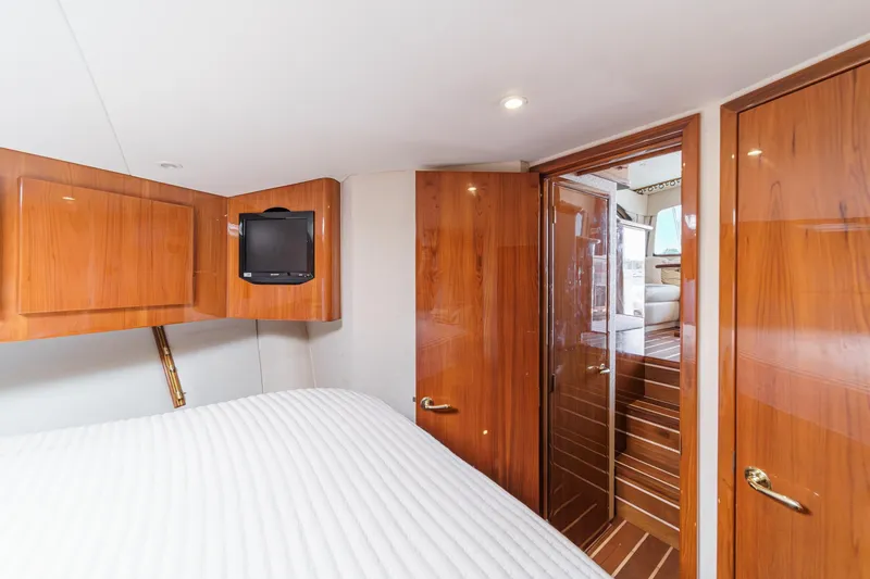 Slide: The Image of Luxurious cabin interior of 2009 Egg Harbor 37 SportYacht with wood finishes and compact TV. - 44