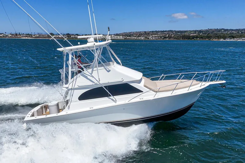 Slide: The Image of 2009 Egg Harbor 37 SportYacht cruising on open water, clear blue sky. - 8