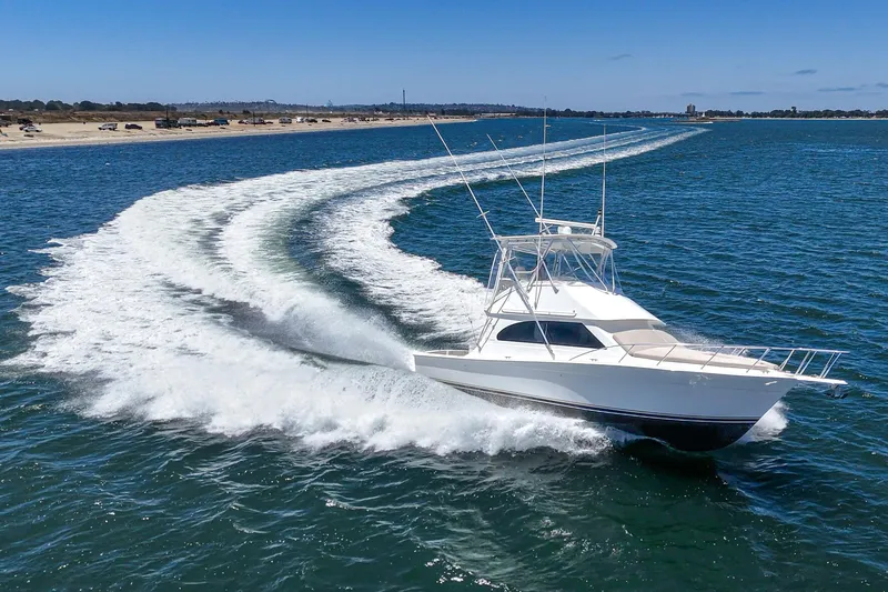 Slide: The Image of 2009 Egg Harbor 37 SportYacht cruising on open water, leaving a wake trail. - 9