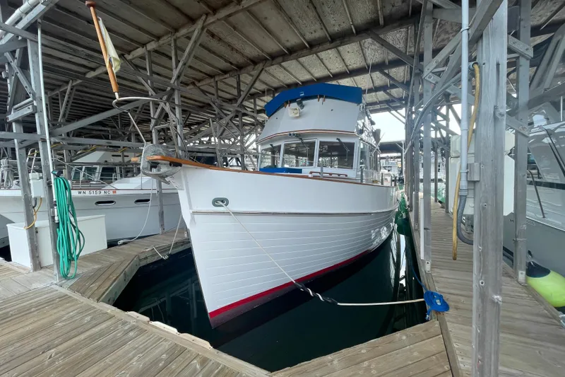 The Image of 1964 Grand Banks 42 Classic yacht docked in a covered marina. - 0
