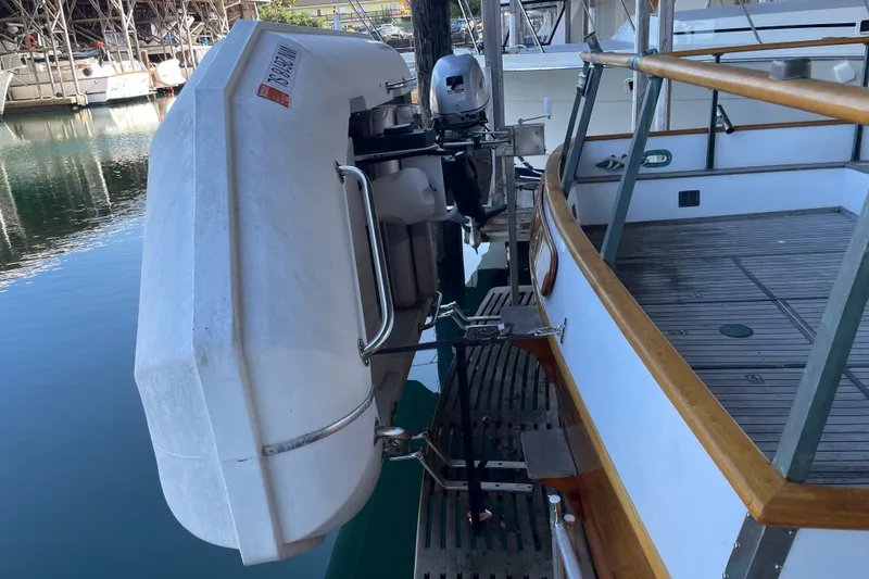 Slide: The Image of Grand Banks 42 Classic yacht with mounted dinghy, docked at marina, 1964 model. - 12