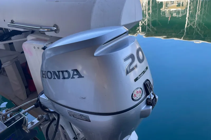 Slide: The Image of Honda 20 horsepower outboard motor on a 1964 Grand Banks 42 Classic boat. - 14