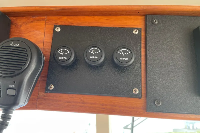 Slide: The Image of Control panel with wiper switches and Icom microphone on a 1964 Grand Banks 42 Classic. - 24