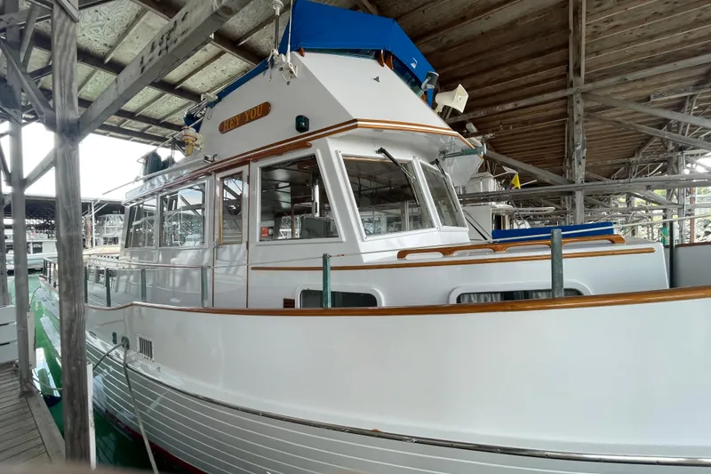 Slide: The Image of 1964 Grand Banks 42 Classic yacht docked in a covered marina. - 3