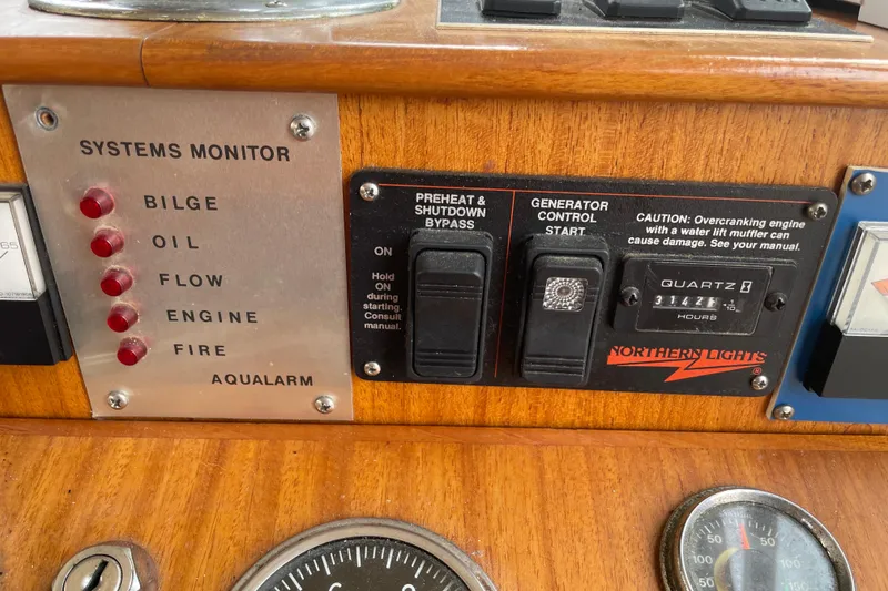 Slide: The Image of Control panel of a 1964 Grand Banks 42 Classic boat with system monitor and generator controls. - 31