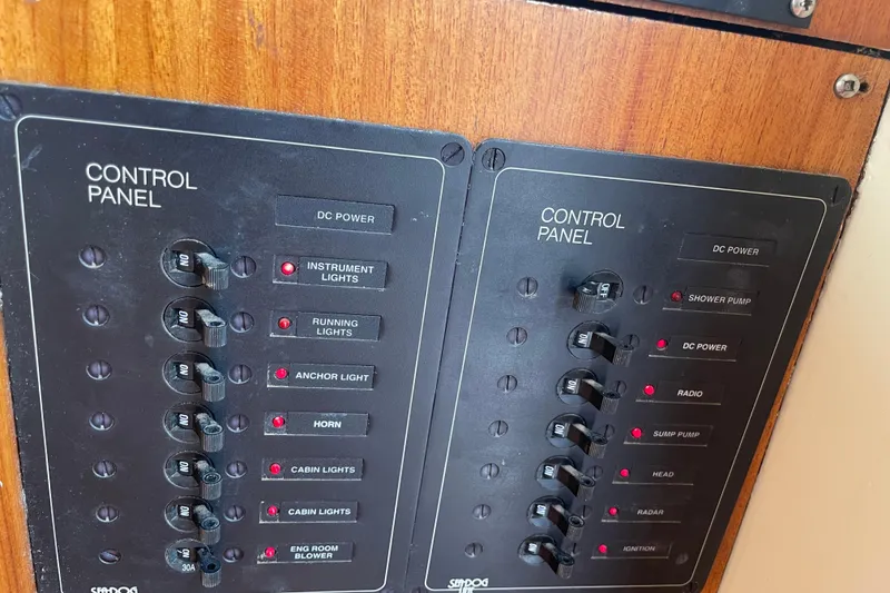 Slide: The Image of Control panel of a 1964 Grand Banks 42 Classic boat with labeled switches. - 34