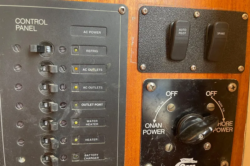 Slide: The Image of Control panel of a 1964 Grand Banks 42 Classic boat with switches and power controls. - 35