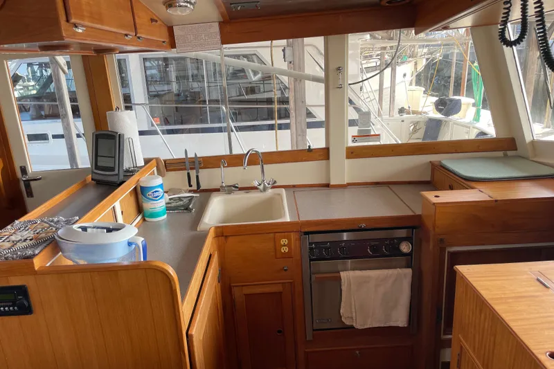 Slide: The Image of Interior of 1964 Grand Banks 42 Classic yacht kitchen with wooden cabinetry and appliances. - 42