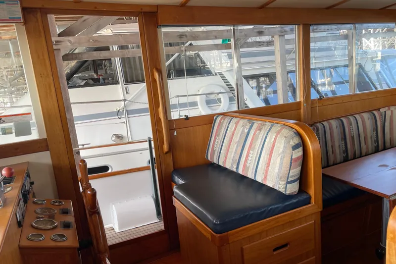 Slide: The Image of Interior of a 1964 Grand Banks 42 Classic yacht with wooden furnishings and striped seating. - 43