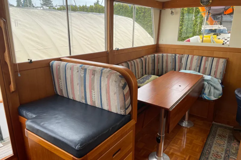 Slide: The Image of Interior of a 1964 Grand Banks 42 Classic yacht with a cozy dining area. - 44