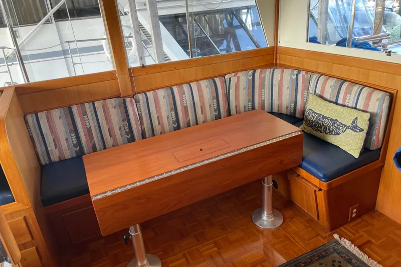 Slide: The Image of Cozy dining area on a 1964 Grand Banks 42 Classic yacht with striped seating. - 45