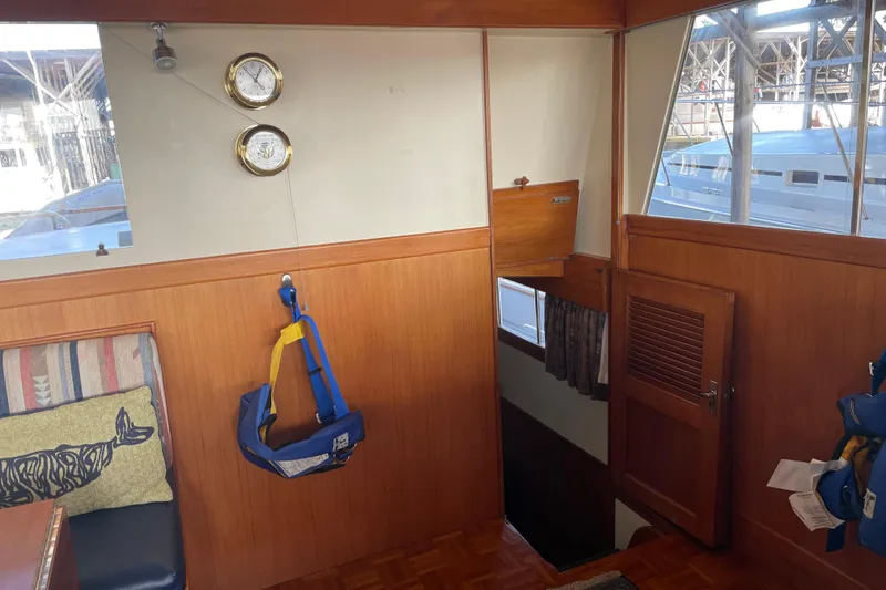 Slide: The Image of Interior of a 1964 Grand Banks 42 Classic yacht with wood paneling and nautical decor. - 46