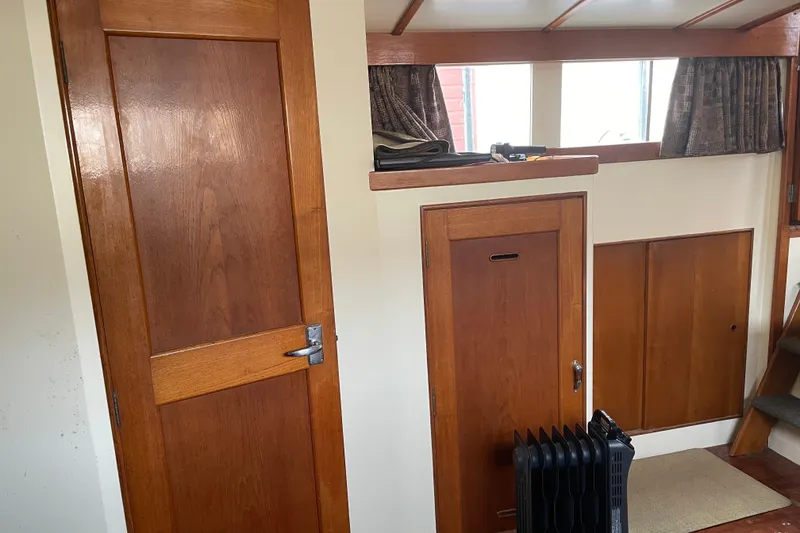 Slide: The Image of Interior of a 1964 Grand Banks 42 Classic boat with wooden doors and paneling. - 54