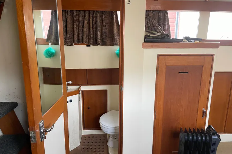 Slide: The Image of Interior of 1964 Grand Banks 42 Classic boat featuring a compact bathroom. - 55