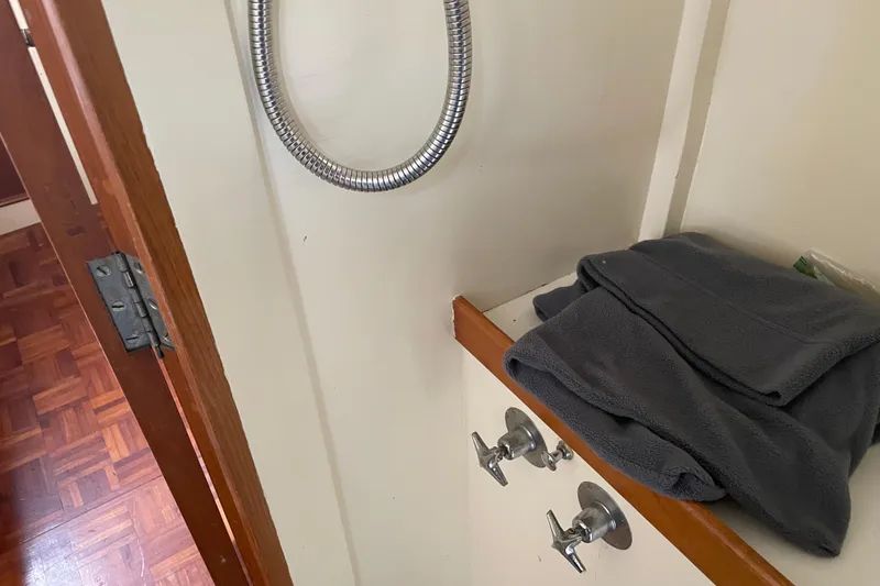 Slide: The Image of Interior of 1964 Grand Banks 42 Classic with folded towels and faucet handles. - 58