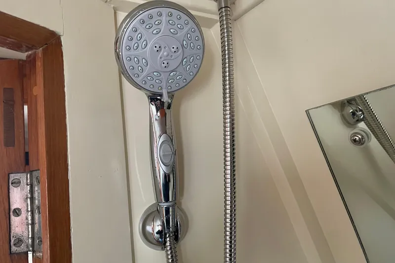 Slide: The Image of Showerhead in a 1964 Grand Banks 42 Classic boat bathroom. - 59