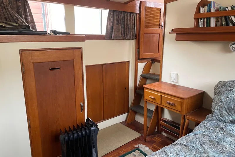 Slide: The Image of Cozy interior of 1964 Grand Banks 42 Classic with wooden furniture and stairs. - 60