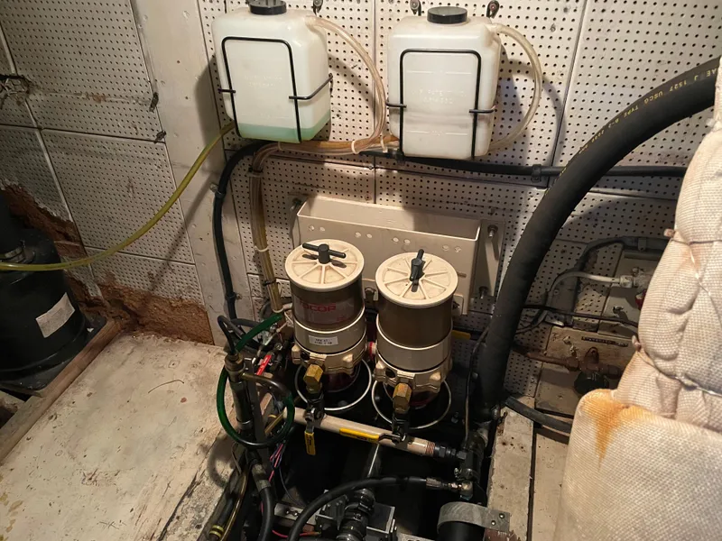 Slide: The Image of Engine room of a 1964 Grand Banks 42 Classic with fuel filters and fluid containers. - 65