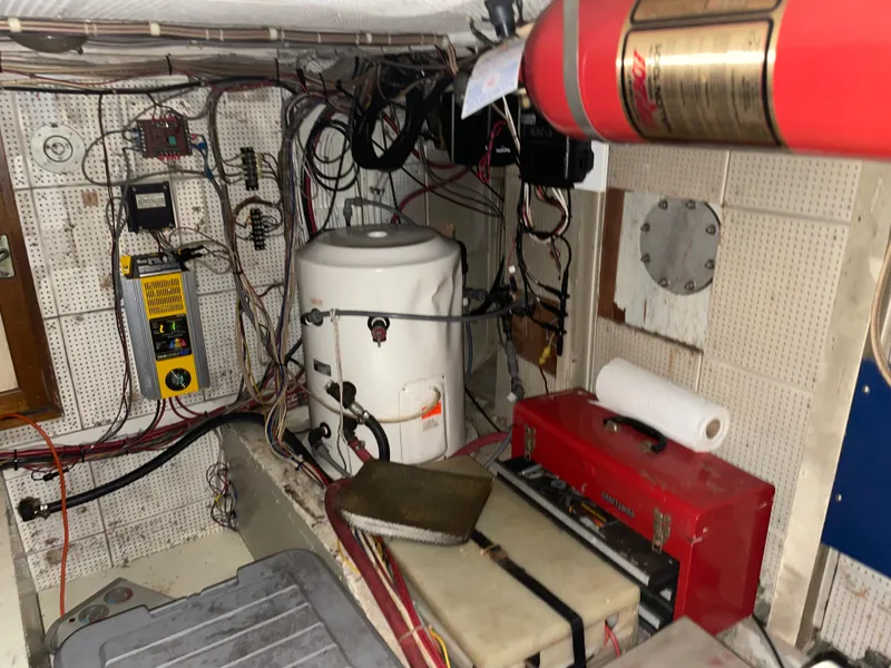 Slide: The Image of Engine room of a 1964 Grand Banks 42 Classic with wiring and equipment. - 66